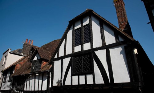 Wooden house roof attics against clear blue sky. Home residential building. Traditional british