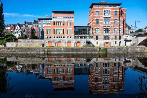 Namur, Wallon Region, Belgium, 07 28 2022, Historical buildings reflecting in the blue water of the