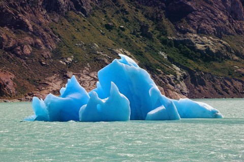 Unique lake Viedma in arid Patagonia. Huge white and blue icebergs floating in the icy water of