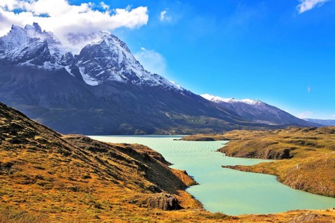 Asure Lake Pehoe water at the foot of the magnificent snow-covered cliffs of Los Kuernos. National