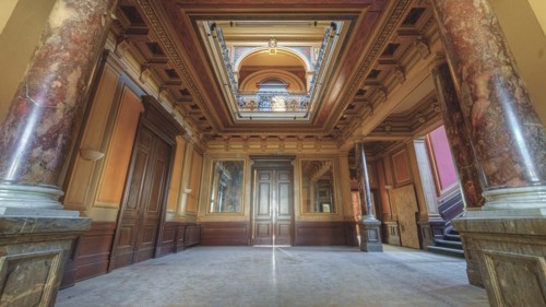 A magnificent corridor with marble columns and richly decorated ceilings in warm colours, Villa