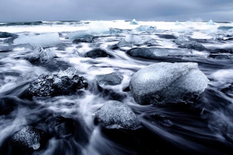 Dramatic seascape with floating blocks of ice and wild waves, Diamond Beach, Iceland, Europe