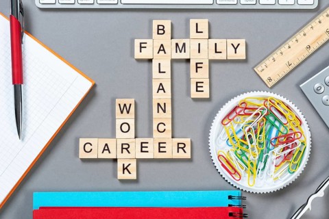 Business motivation concept with words from cubes. Still life of office workplace with crossword.