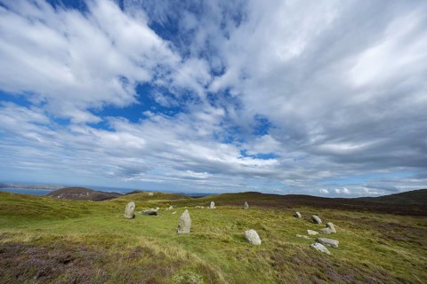 Druids Circle, stone circle in wide landscape with pastures in the mountains, Penmaenmawr,