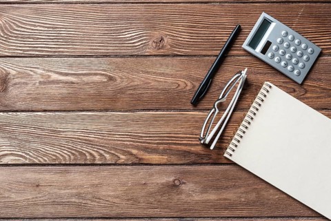 Still life of accountant vintage workspace with office accessories. Flat lay old hardwood desk with