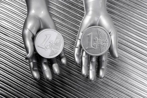 Two silver euro coins in futuristic robot gray metallic hands bank metaphor