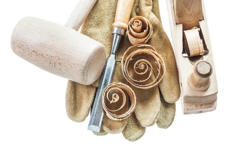 Safety gloves chisel shavings wooden hammer planer isolated on white