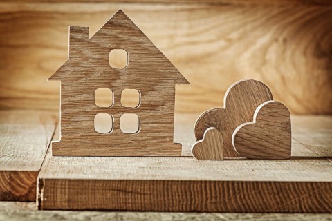 Vintage wooden toys house and three hearts on wood background