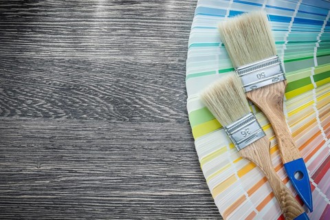 Paint brushes color palette on wood board