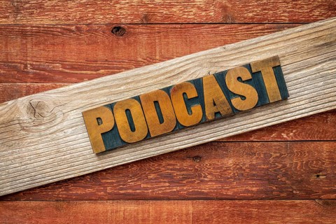 Podcast rustic sign - letterpress wood type over grained cedar plank against red barn wood