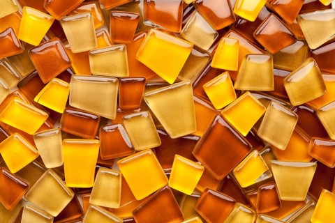 Random background of yellow, brown and amber glass mosaic tiles