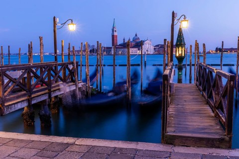 Venetian gondolas, boat dock at St Mark's Square, church of San Giorgio Maggiore in the background,