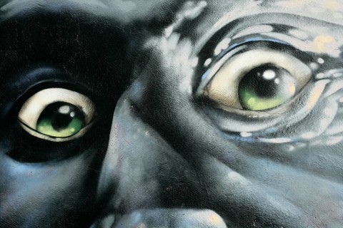 Portrait of angry man, graffiti over concrete, red, gray, green