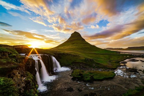 View of mount Kirkjufell and Kirkjufellfoss in Iceland at sunset