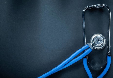 Stethoscope on black background top view medicine concept
