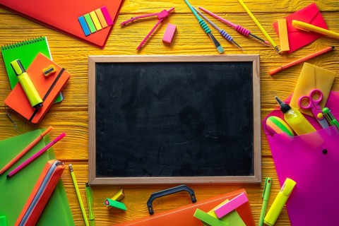Back to school supplies arrangement vivid colorful neon color in yellow background desk