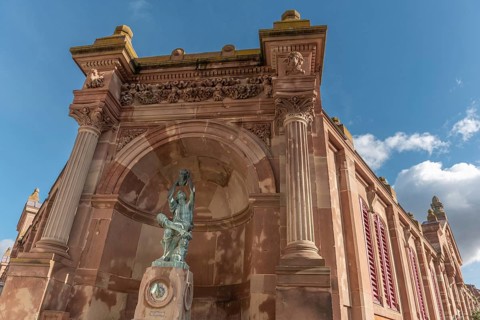 The statue of the winegrower, work of Auguste Bartholdi in front of the covered market in the city