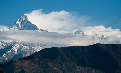 The famous Annapurna massif mountains in the Himalayas covered in clouds, snow and ice in north