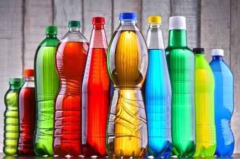 Plastic bottles of assorted carbonated soft drinks in variety of colors