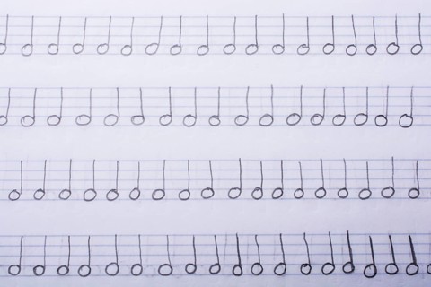 Hand written musical notes are found on paper