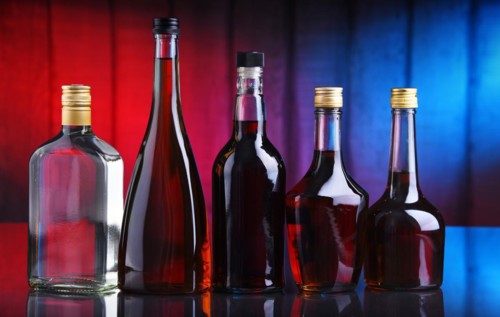 Composition with bottles of assorted alcoholic beverages