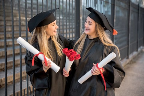 Medium view friends with bouquet roses graduation