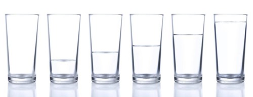 Six glasses with cold still water isolated on white background