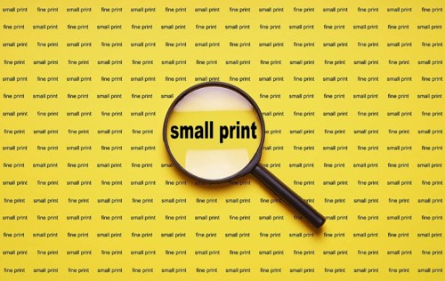 small print enlarged with magnifying glass magnifier loupe, business concept