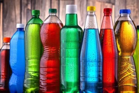 Plastic bottles of assorted carbonated soft drinks in variety of colors