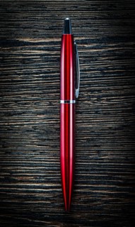Red biro pen on vintage wooden board