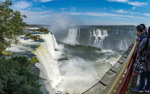 Foz do Iguacu, Brazil, july 9, 2016: Cataratas waterfalls view from the top with some rocks covered