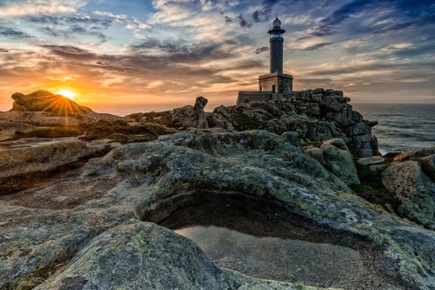 A beautiful sunset at the Punta Nariga lighthouse in Galicia