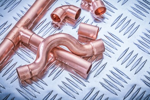 Copper pipe fixings on corrugated sheet metal Sanitary concept