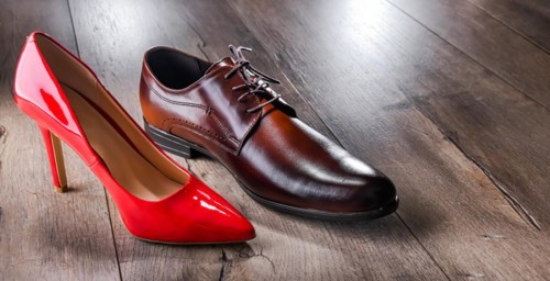Composition with a high heel women's shoe and a men's shoe