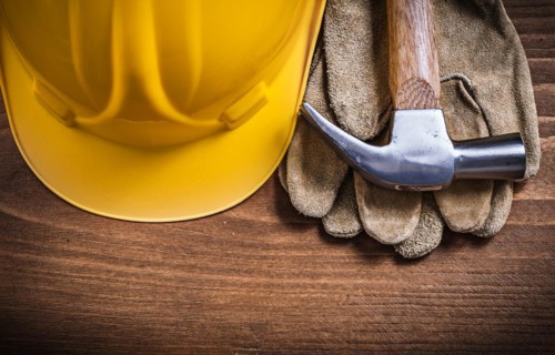 Claw hammer building helmet protective gloves construction concept