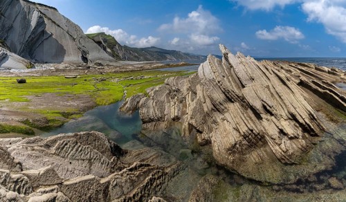 A view of the Flysch rock formations and cliffs with tidal pools on the Basque Country coast near