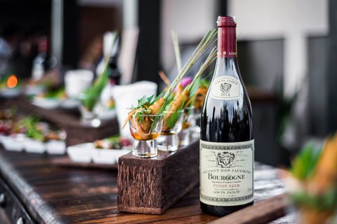 Bottle of red bourgogne wine at oudoor party bar counter