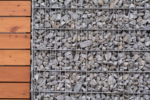 Close-up of stone-wood fence - text free space
