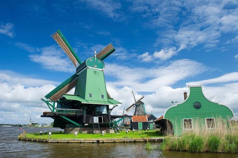 Green windmill at the Dutch Zaanse Schans near the river