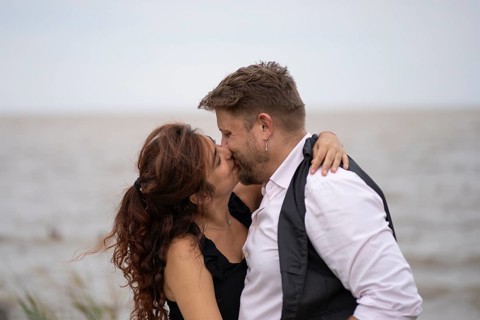 Lovers hug and kiss on a beach