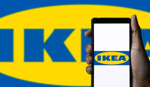 The logo of the IKEA store on the screen of a smartphone.