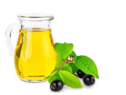 Olive oil and olives wiyh green leaves against white background