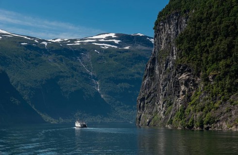 People on cruise boat at the famous geiranger fjord waterfalls in norway