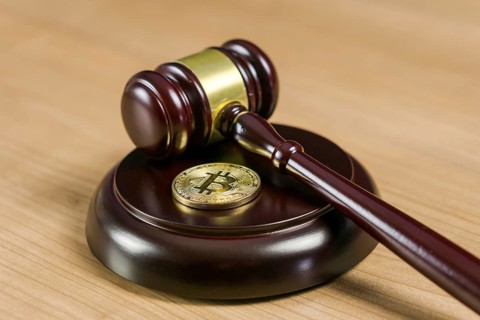 Photo of Bitcoin Regulation. BTC crypto coin and gavel on a desk