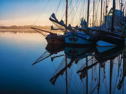 Sailing ships in the morning in the city harbour of Rostock