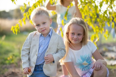 Little boy in a suit on the background of his sister
