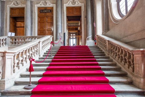 Turin, Italy, Circa January 2022: red carpet in Royal Palace, luxury elegant marble stairway,