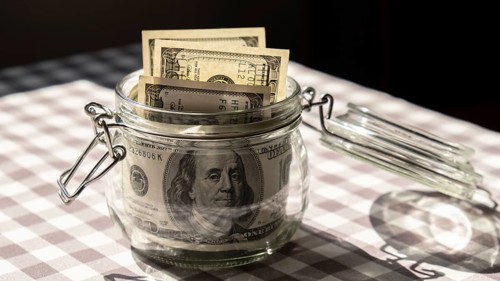 Dollar banknote saving money in glass jar. Consumption and economy Collecting money. Tips.