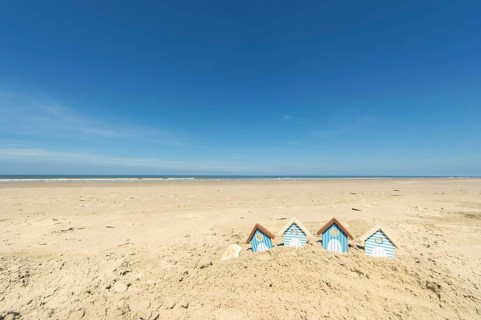Summer beach with landscape and wooden huts