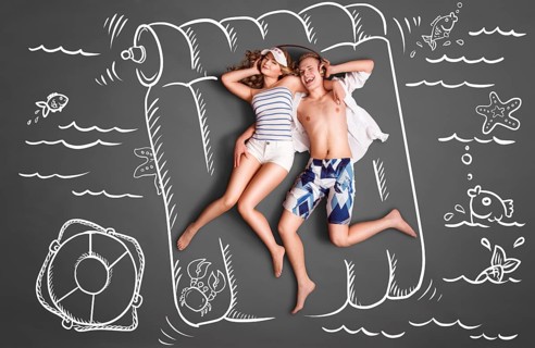 Happy valentines love story concept of a romantic couple lying on an air mattress, sharing